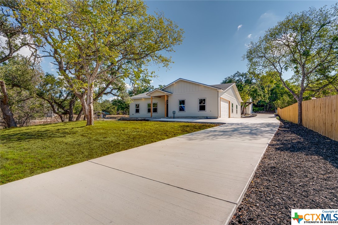 a view of house with garden and trees