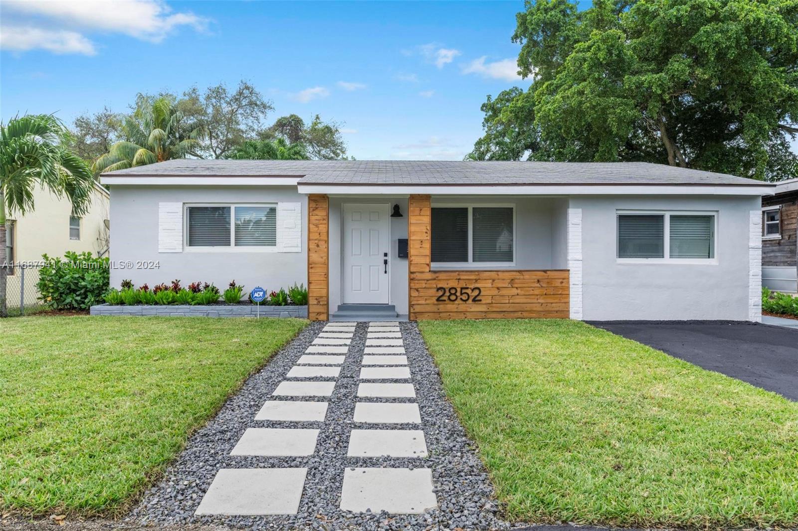 a front view of house with yard and green space