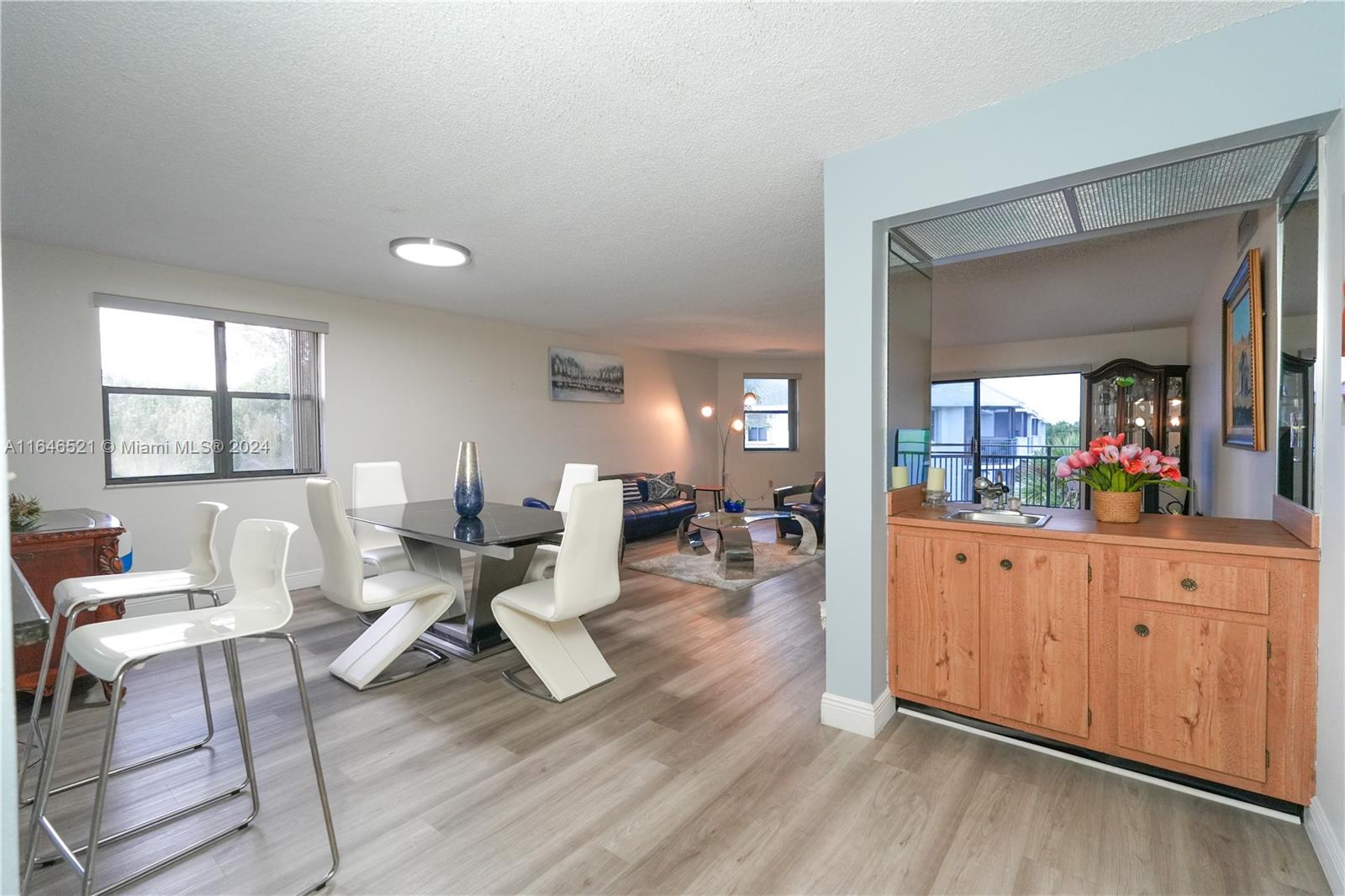 a living room with furniture a window and wooden floor