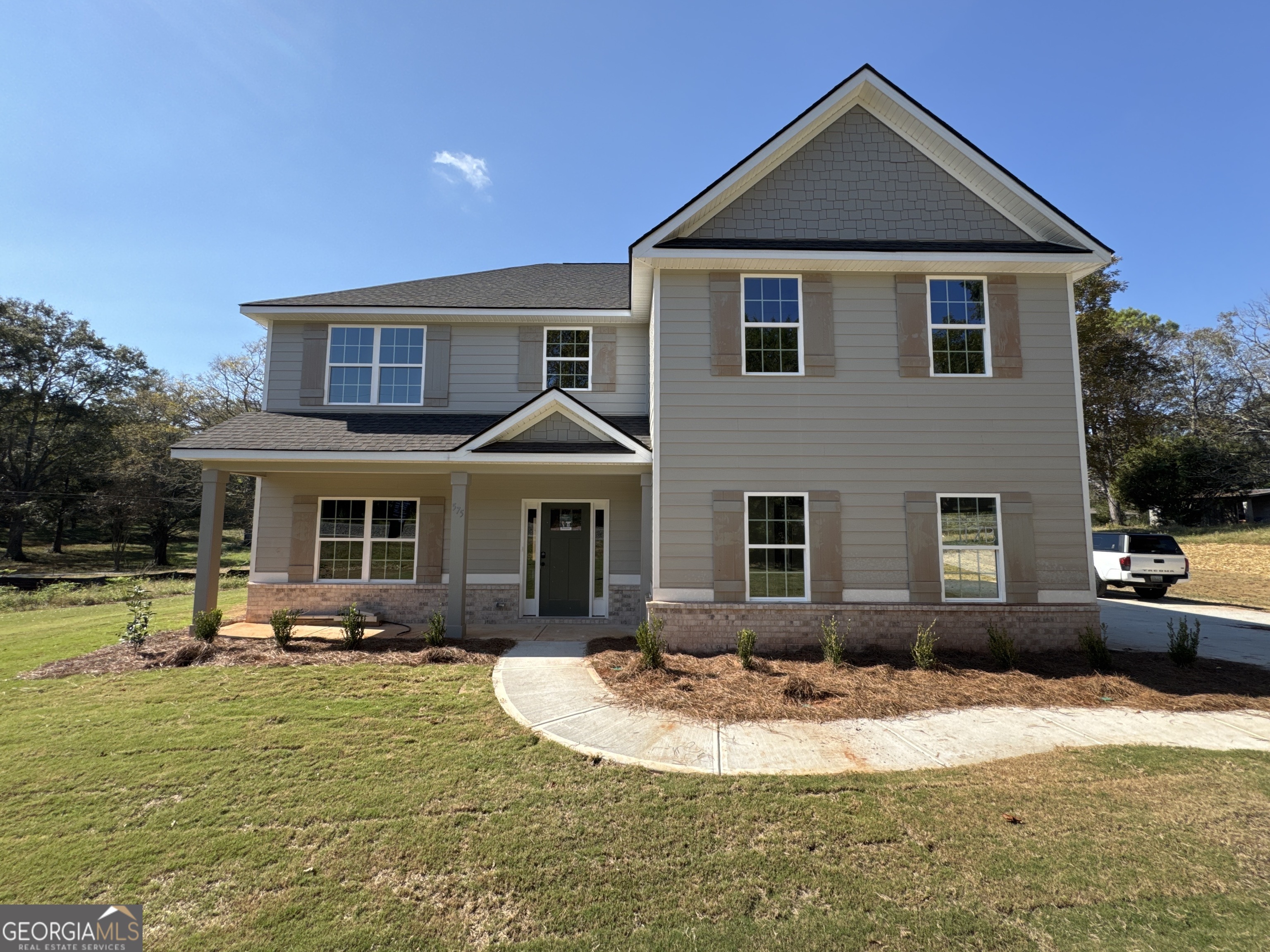 a front view of a house with garden