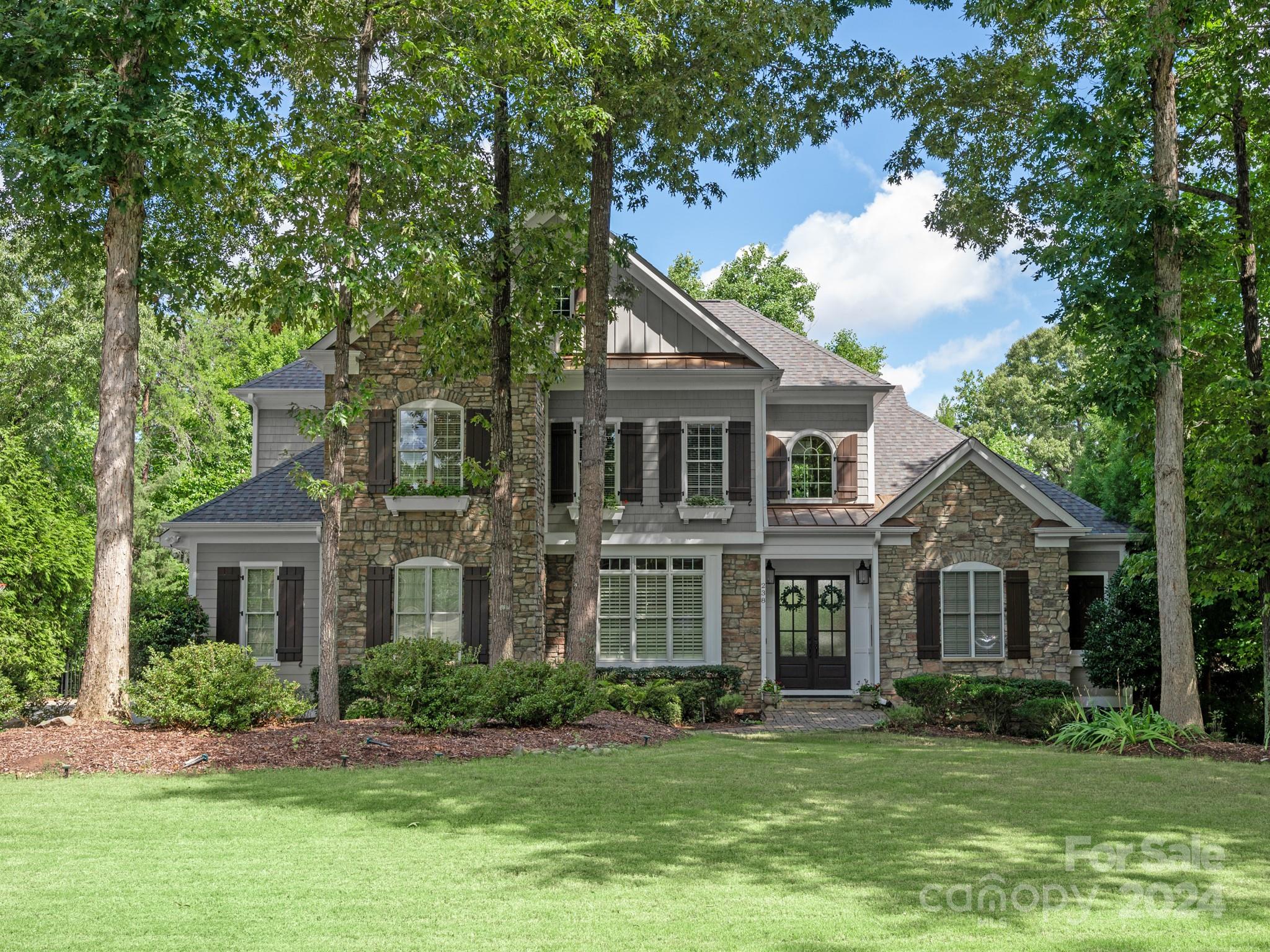 a front view of a house with a garden