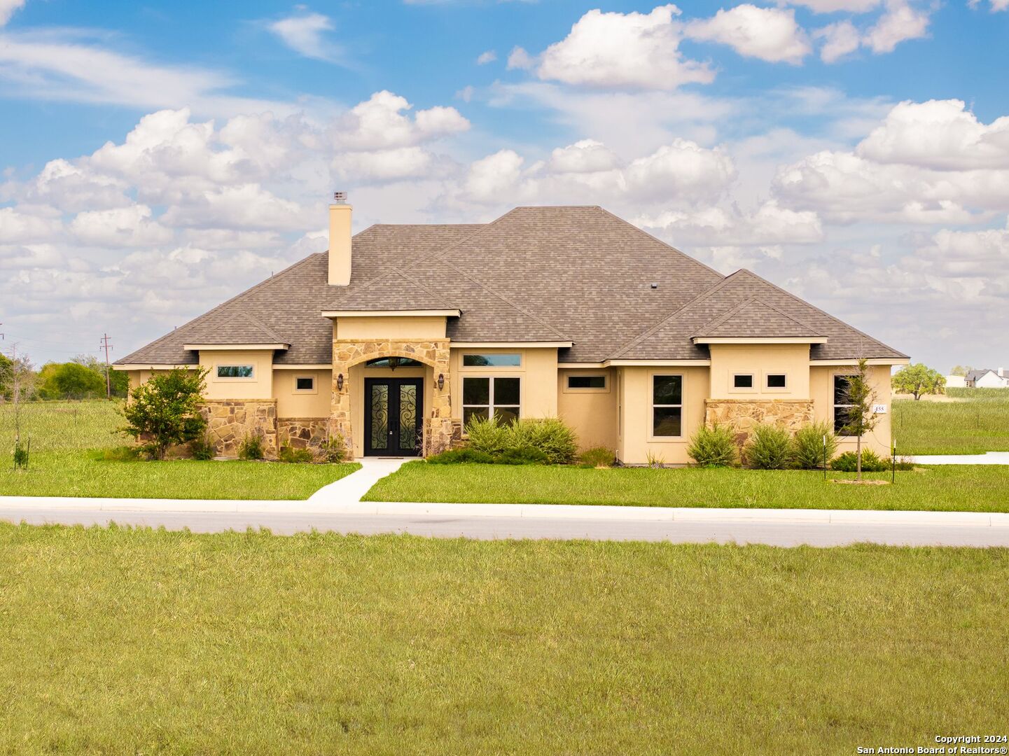 a big house with a big yard and large trees