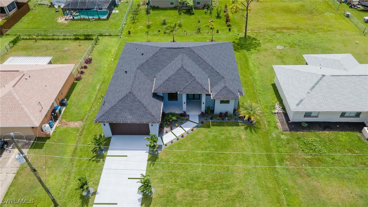 an aerial view of a house with a swimming pool