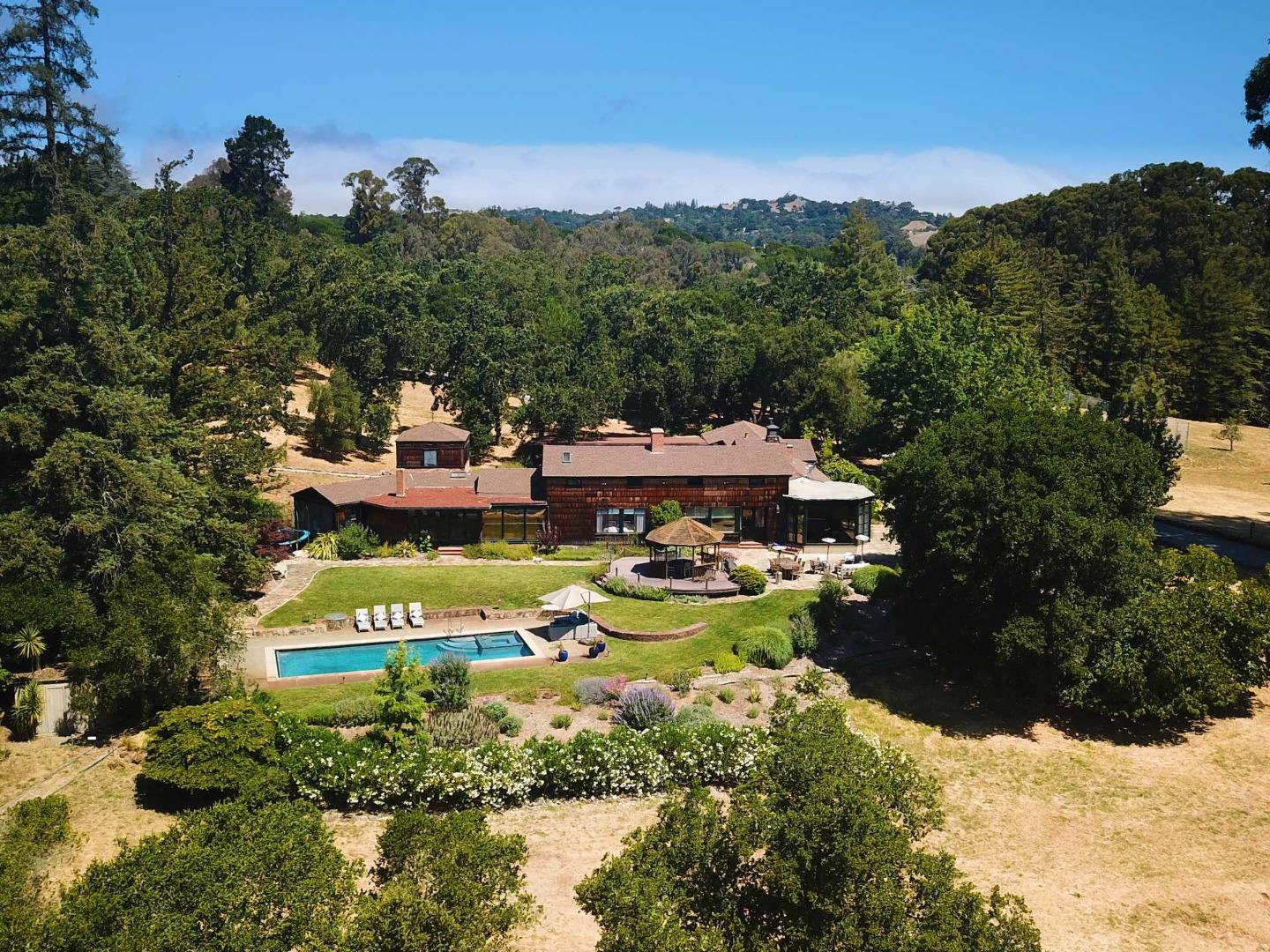 a view of a house with pool outdoor seating and yard