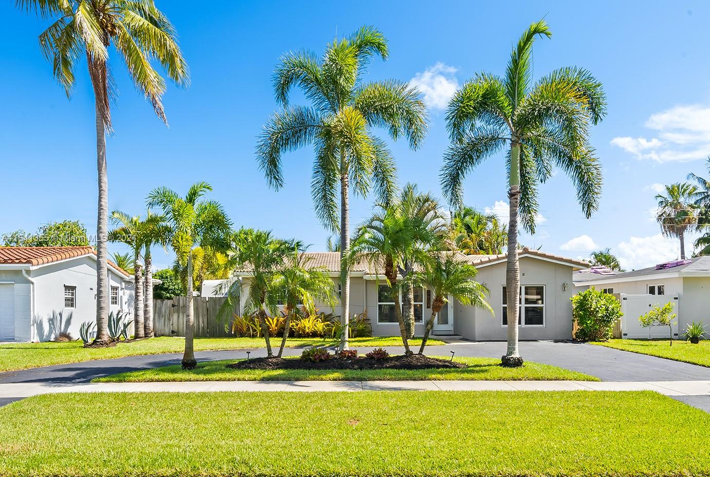 a view of a palm trees in front of a house