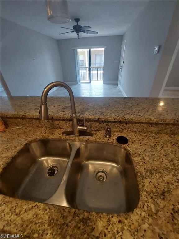 a view of a sink a faucet a washer and dryer