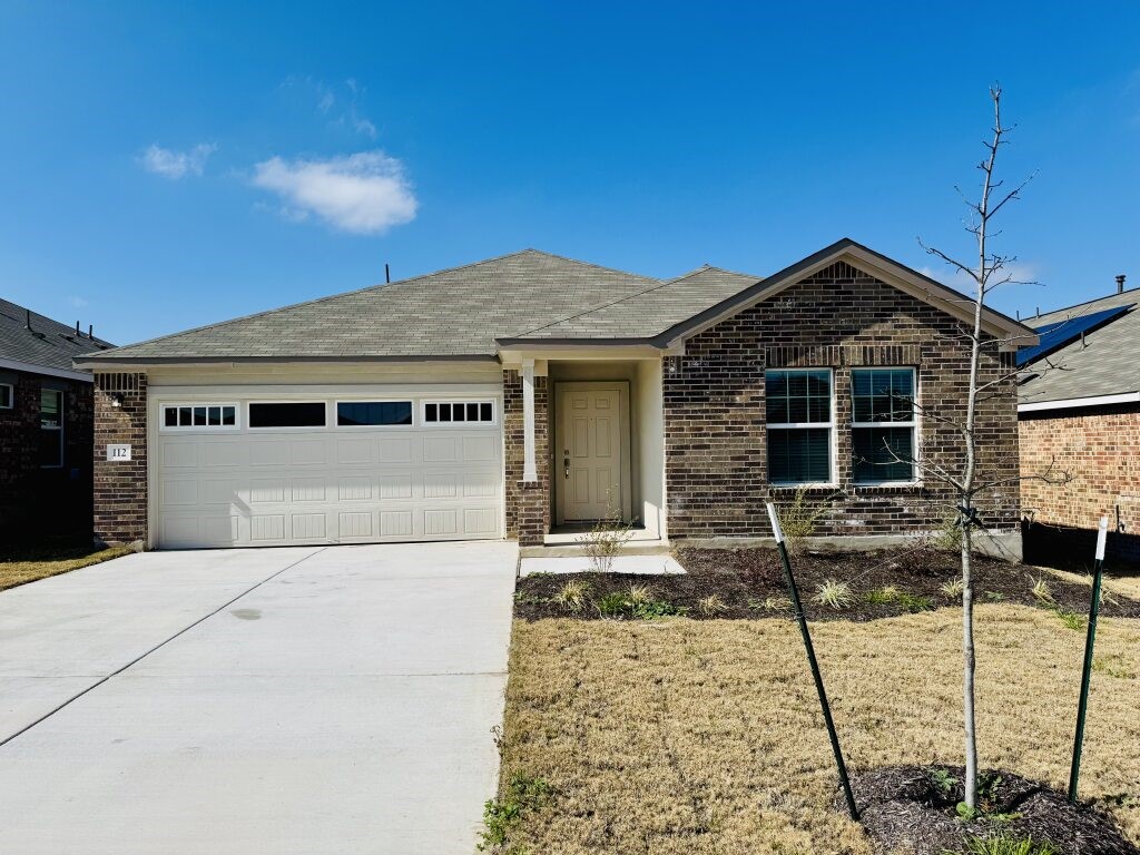 a front view of a house with parking space