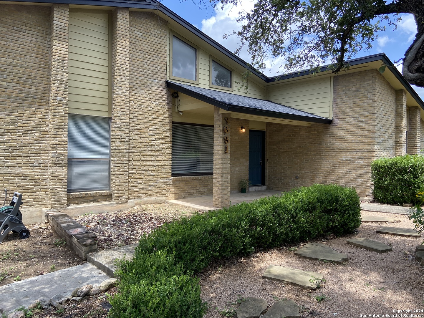 a front view of a house with garden