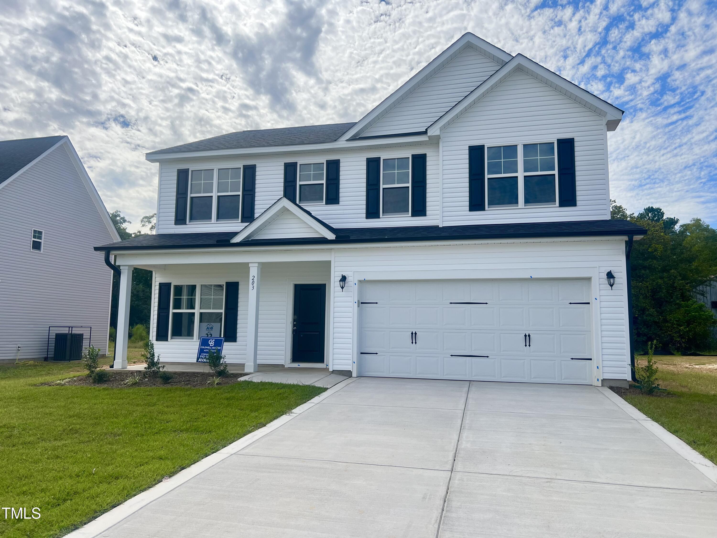 a view of a yard in front view of a house