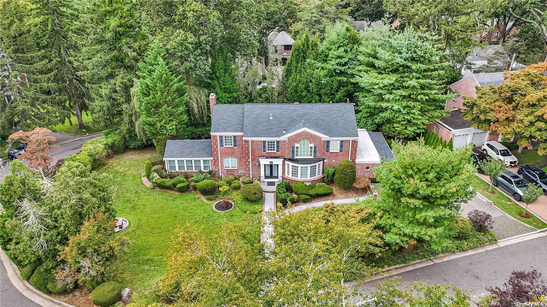 an aerial view of a house with garden space and street view