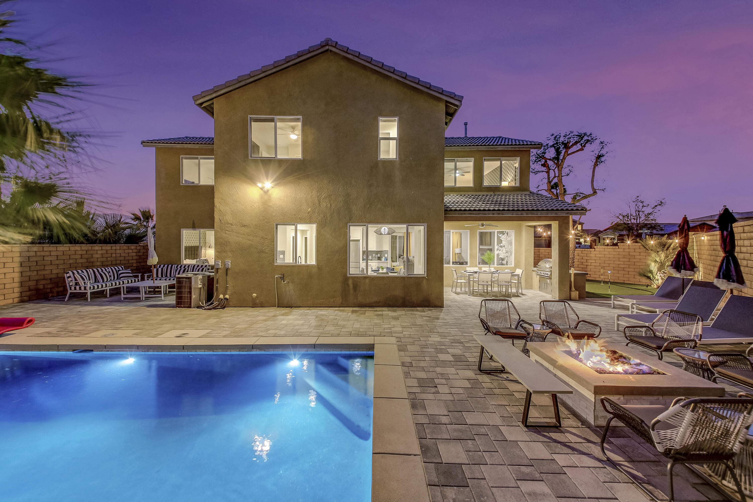 a view of a house with swimming pool and sitting area