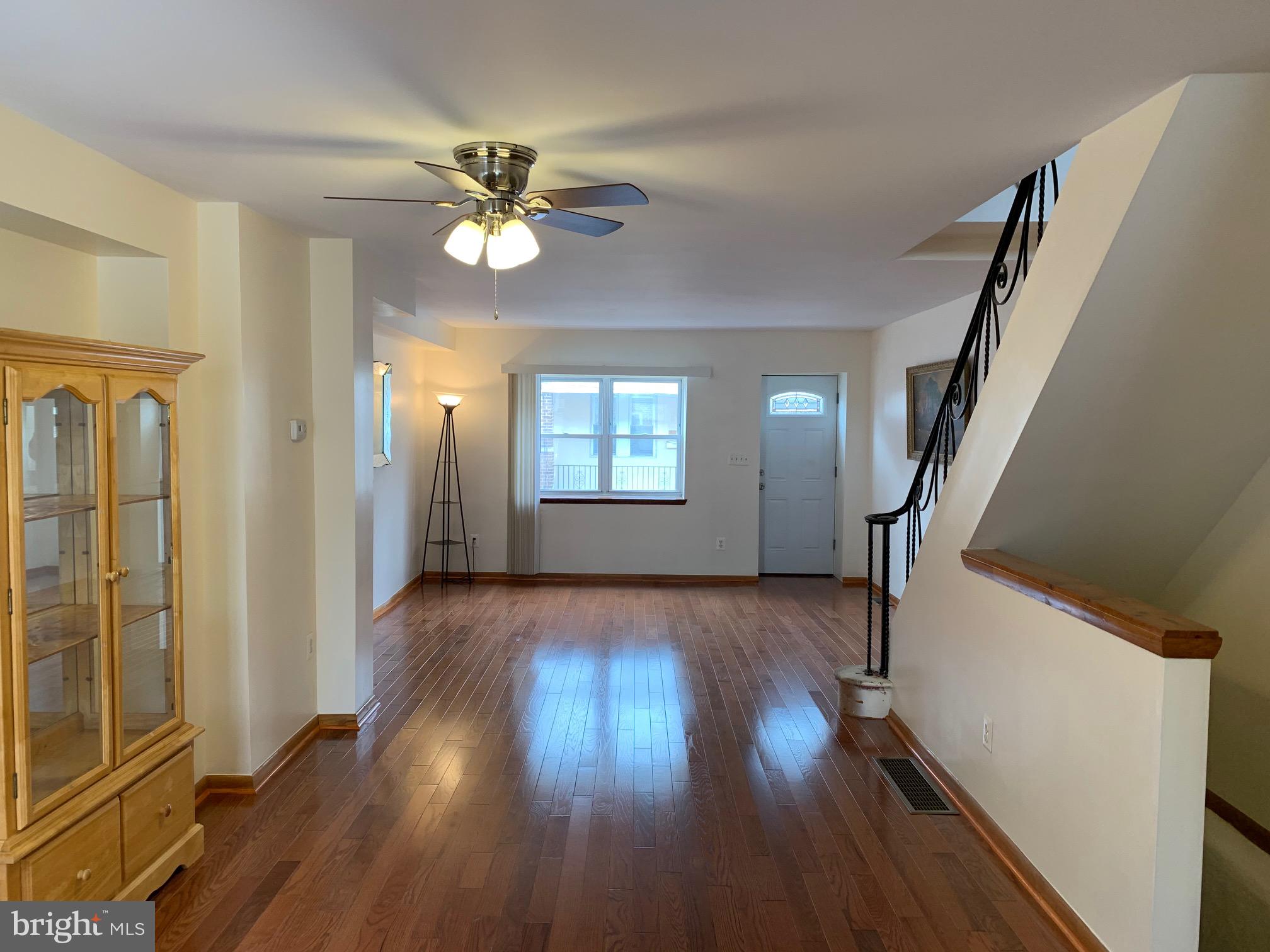 wooden floor in an empty room with a mirror