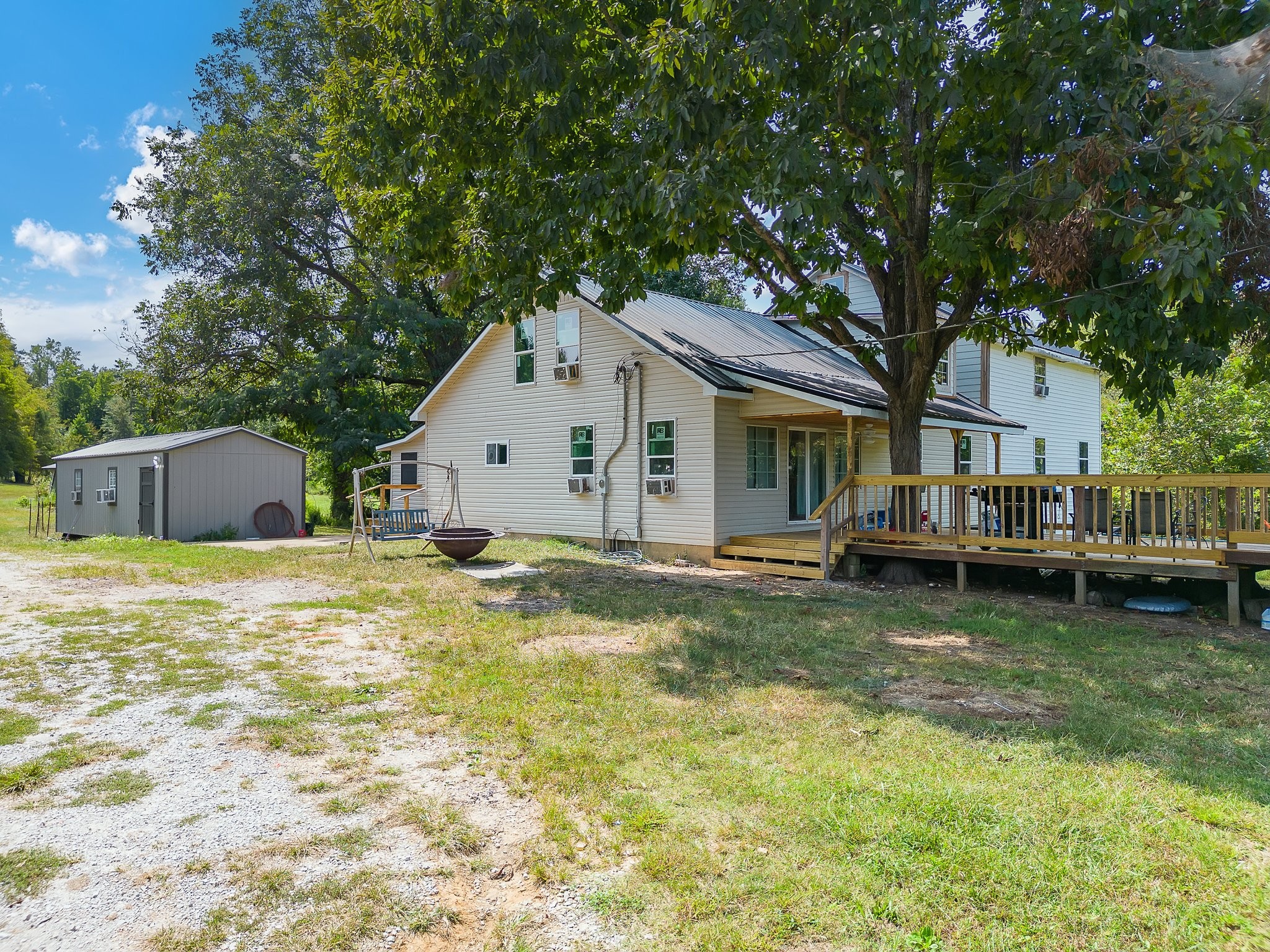 a view of a house with swimming pool and a yard