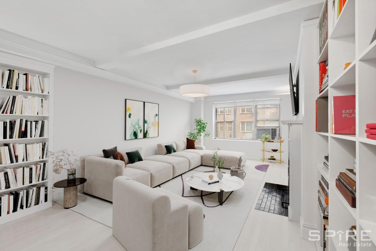 a living room with furniture and a book shelf