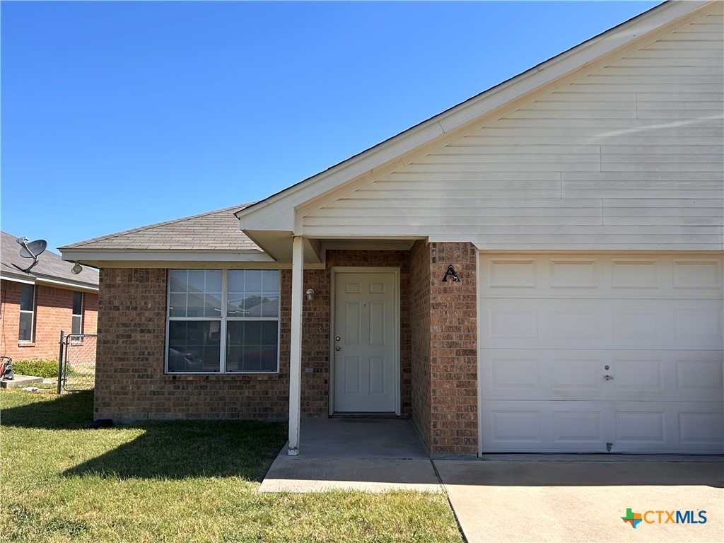 a view of house with backyard