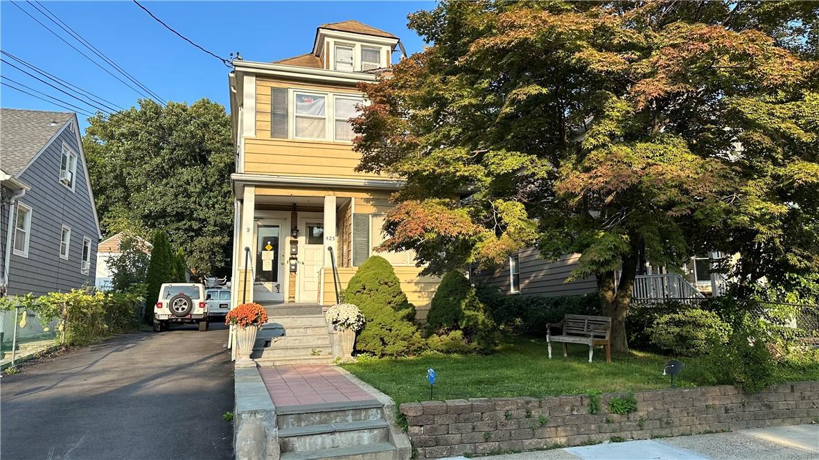 a front view of a house with a yard