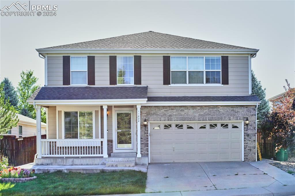 Front of property featuring a 2 car garage and porch