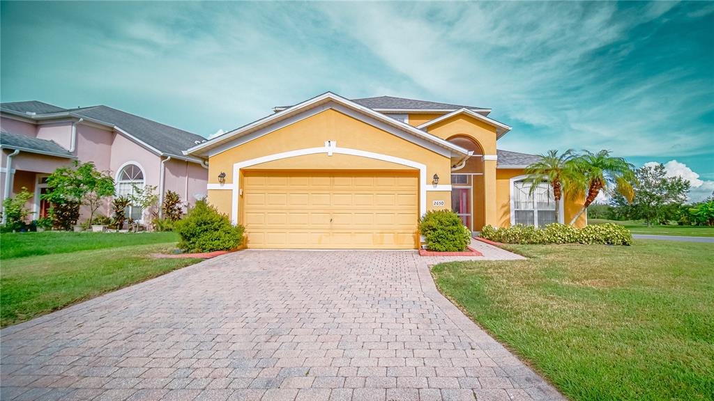 a very nice looking house with a big yard and large trees