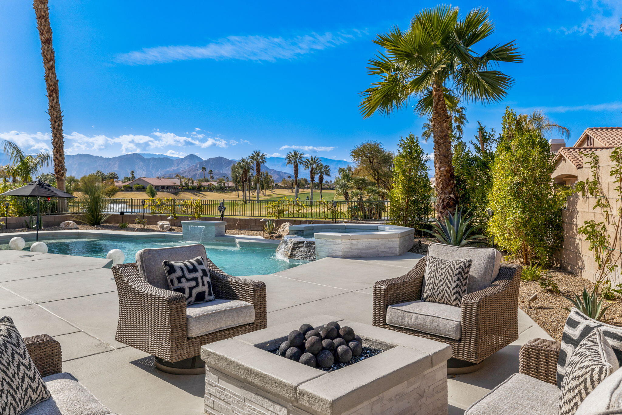 a view of a patio with couches and a table and potted plants