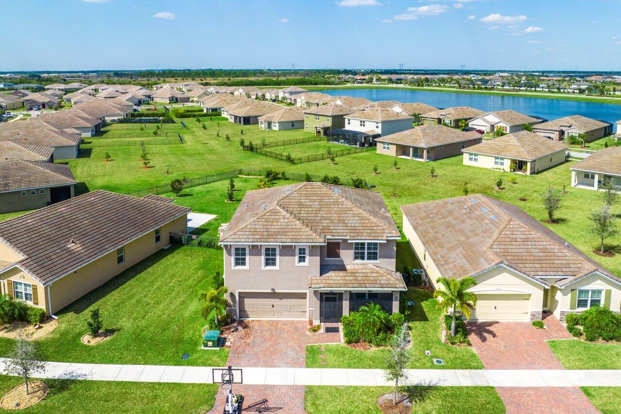 an aerial view of a house with a garden and lake view