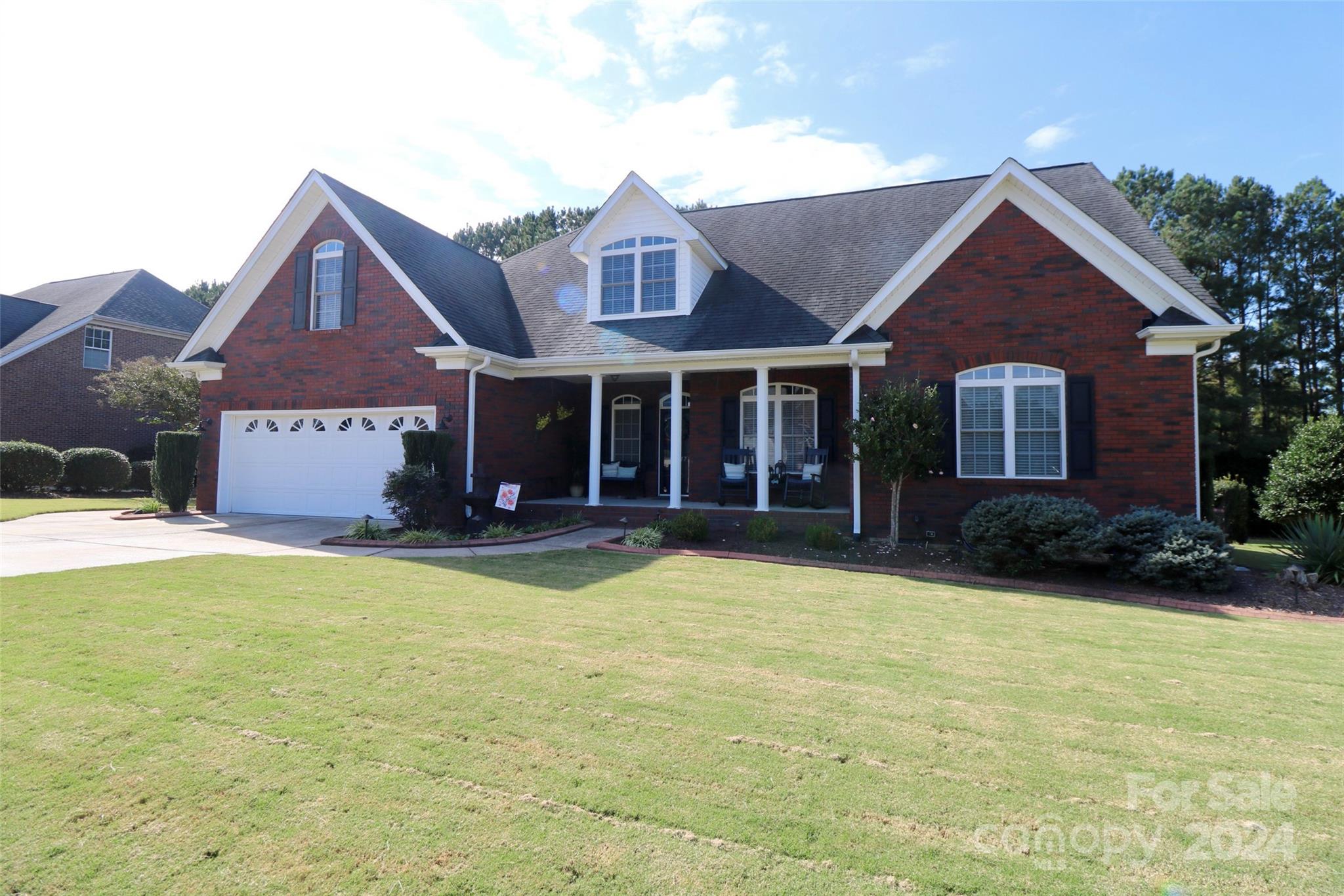 a view of a house with swimming pool and a yard