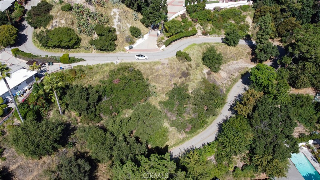 an aerial view of a residential houses with yard