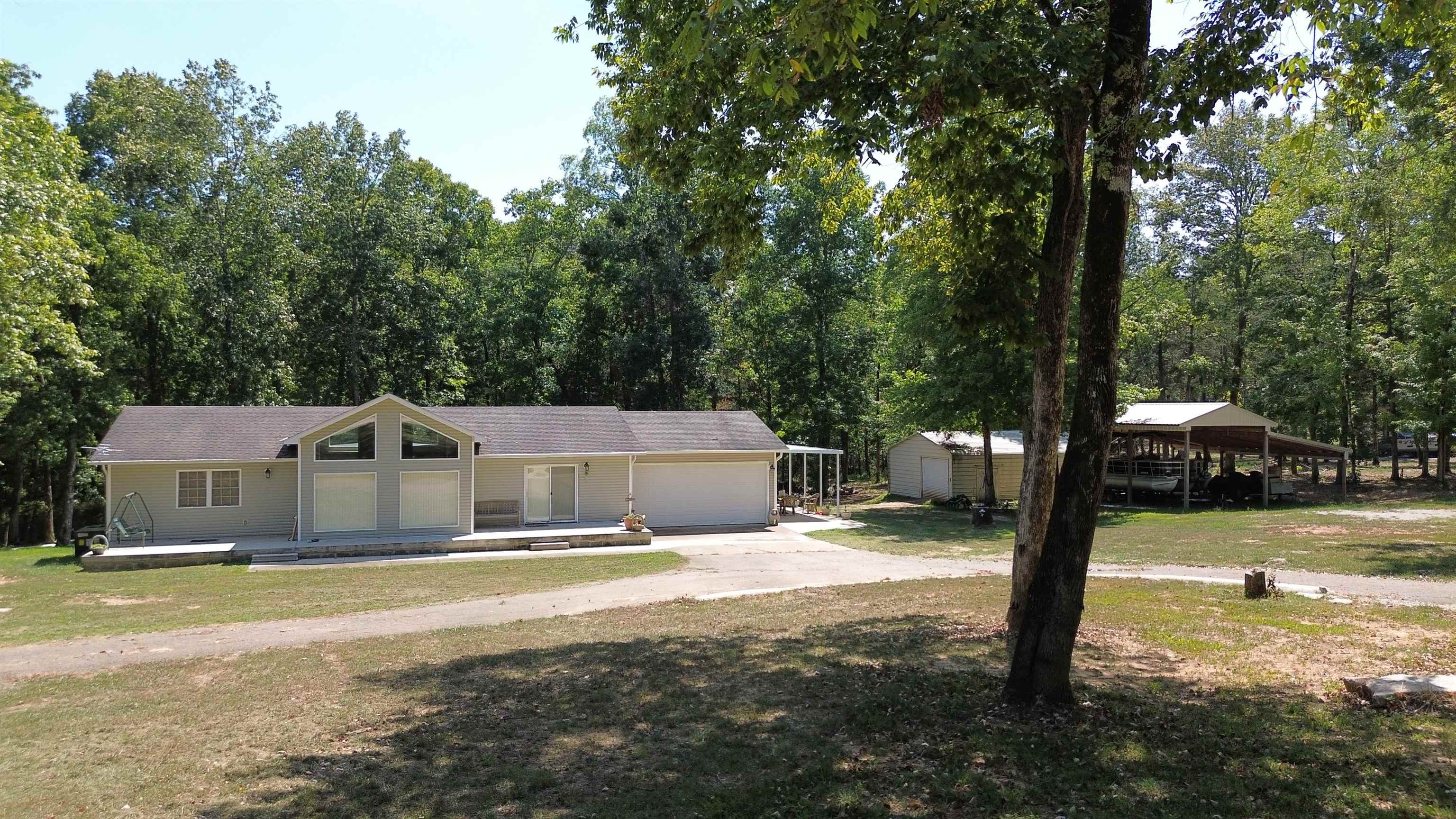 a view of a house with swimming pool and yard