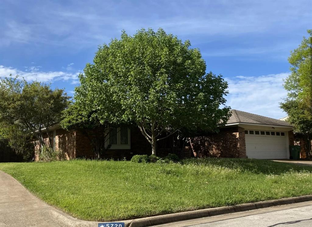 front view of a house with a garden