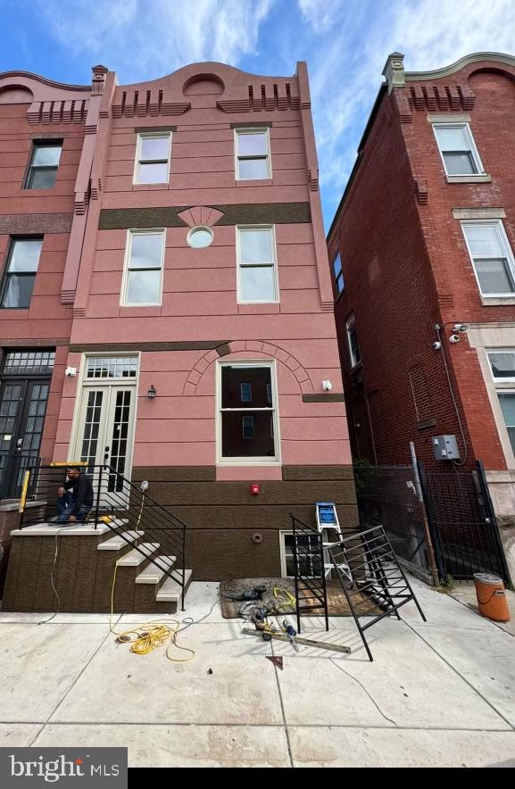 a view of a brick house with many windows