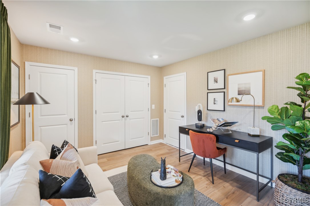 a living room with furniture and wooden floor