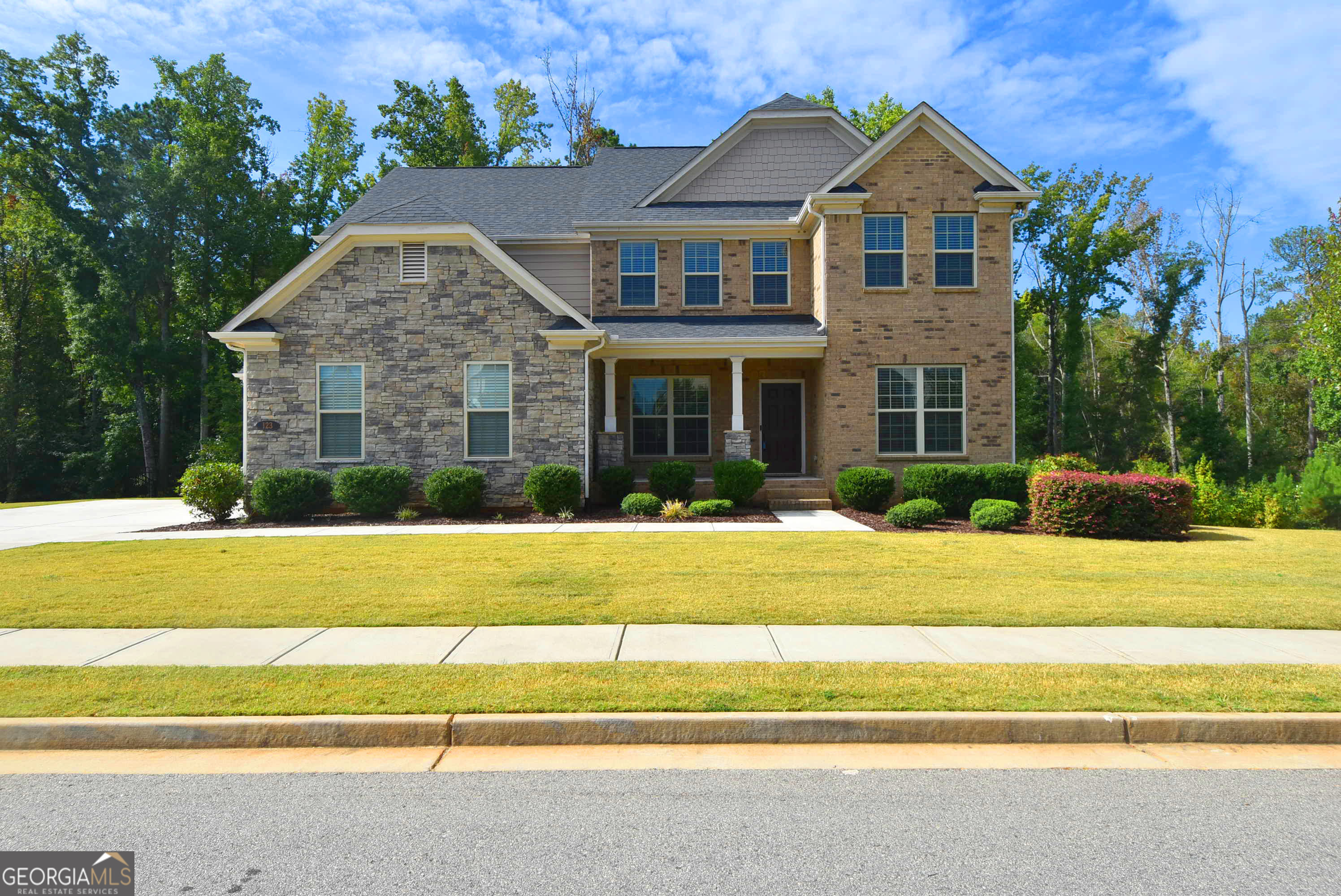 a front view of a house with a yard