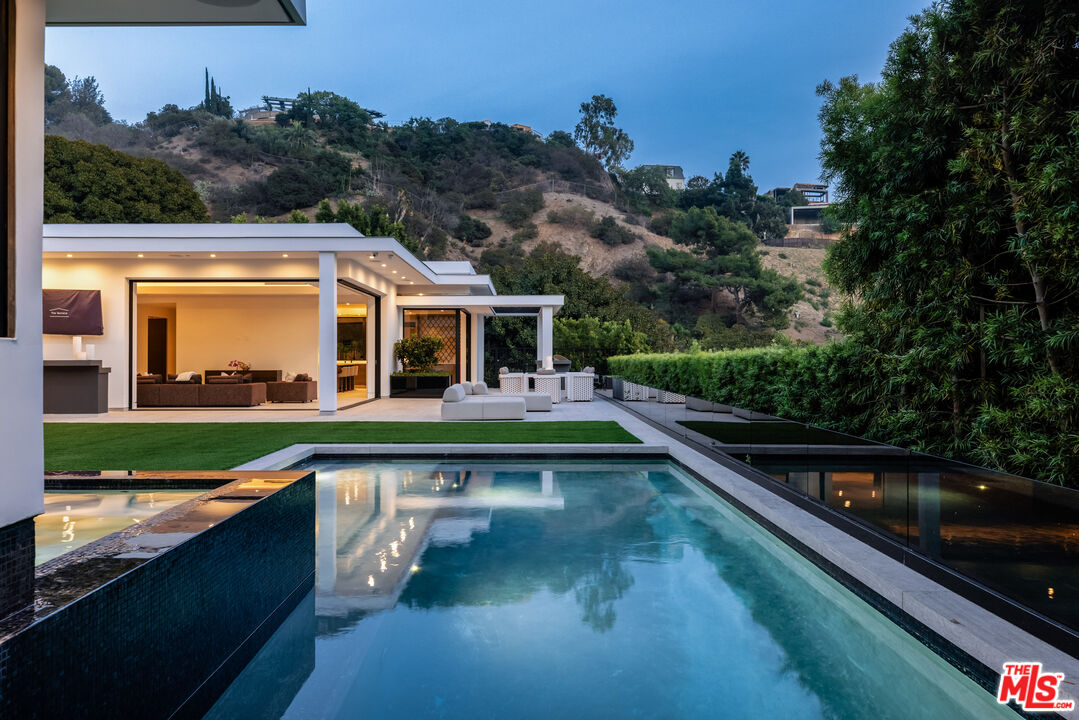 swimming pool view with a seating space