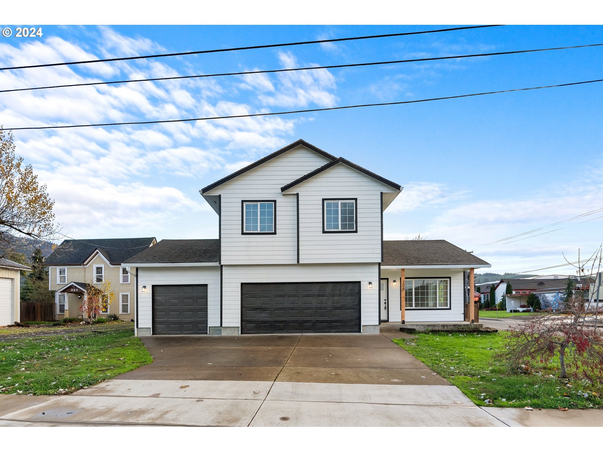 a front view of a house with a garden and garage