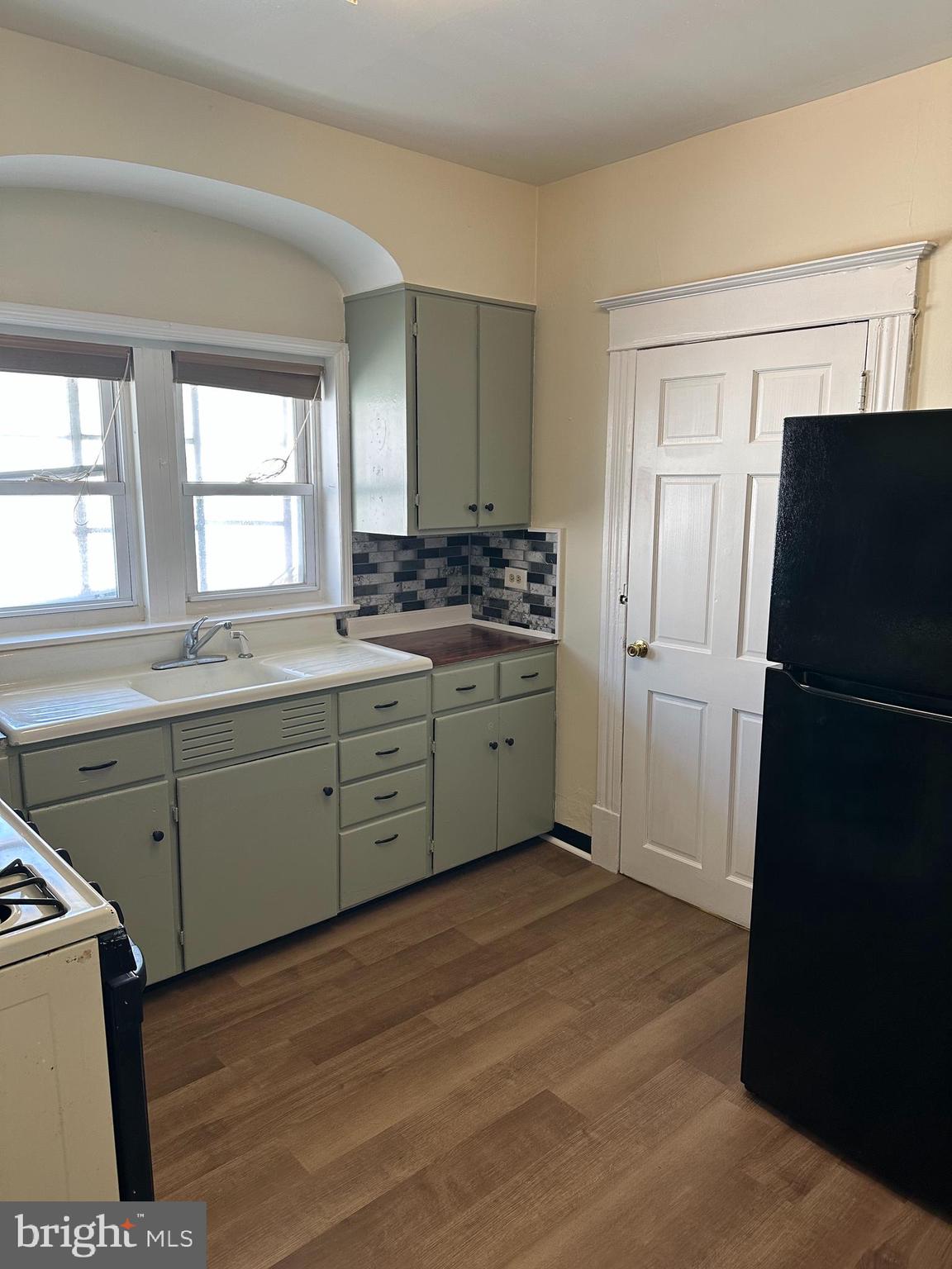 a kitchen with a refrigerator sink and cabinets