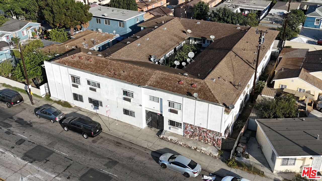 an aerial view of residential houses with yard