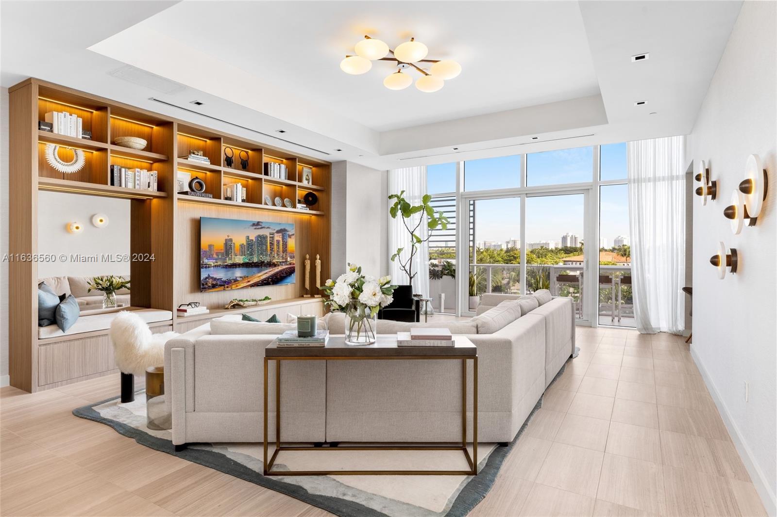 a room with stainless steel appliances kitchen island granite countertop a sink and a refrigerator