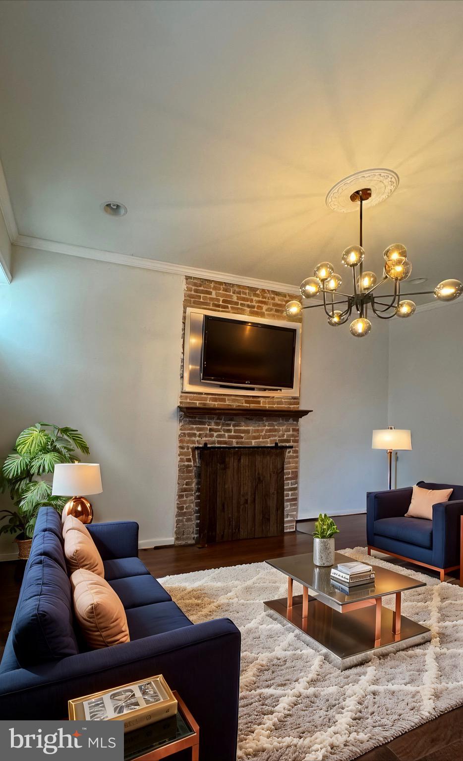 a living room with furniture a fireplace and a flat screen tv