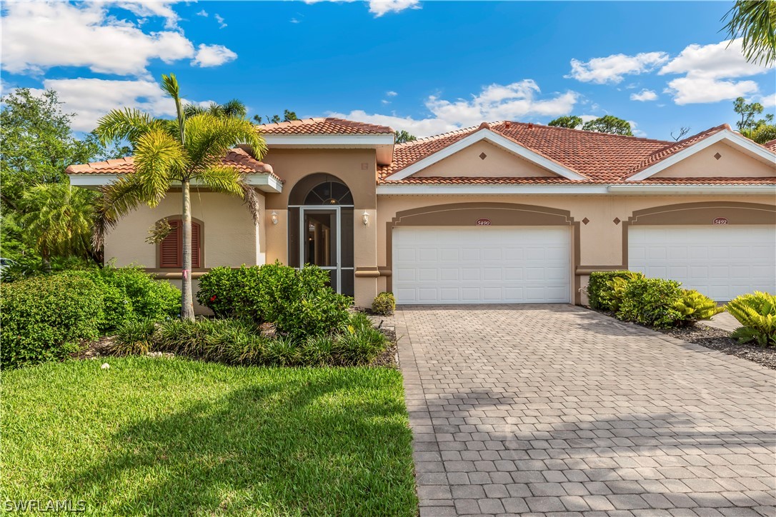 a front view of a house with a yard and garage