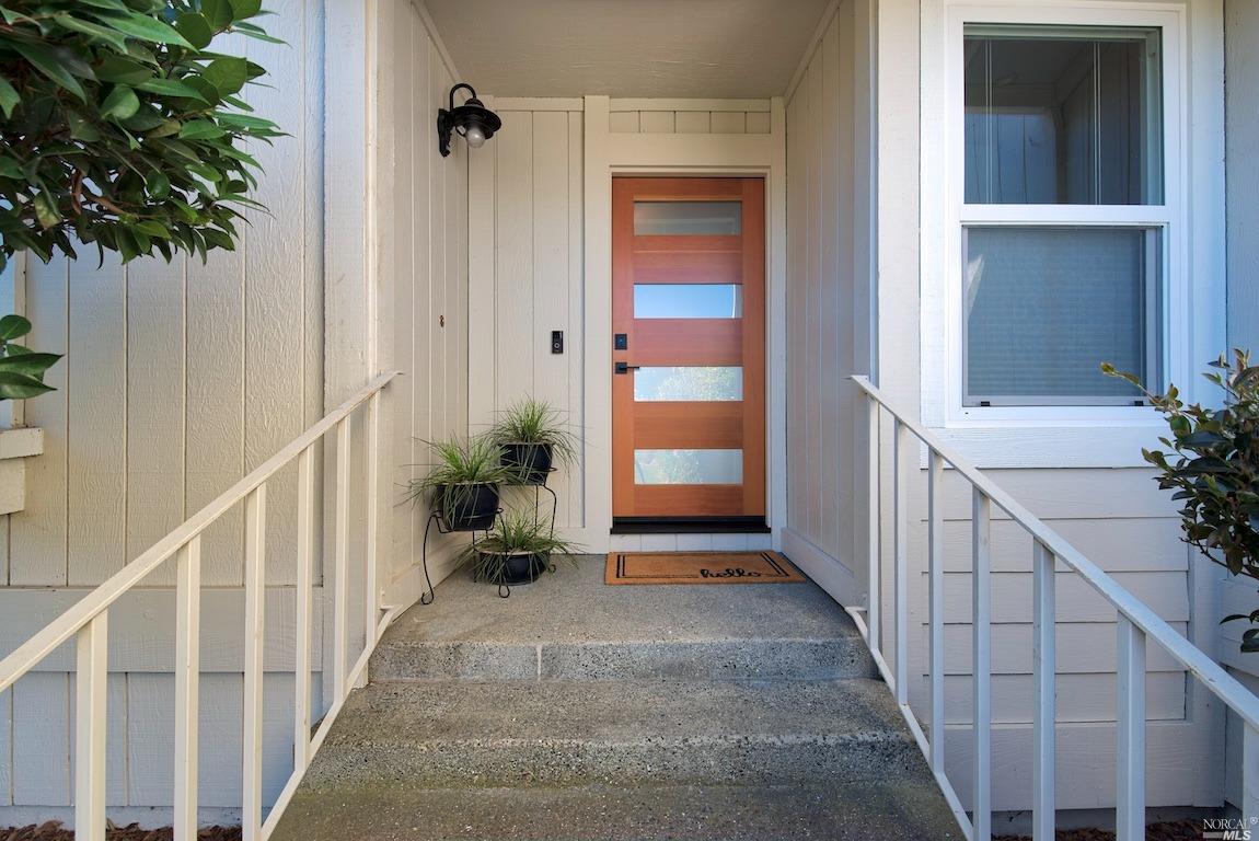 a view of an entryway with wooden floor and stairs