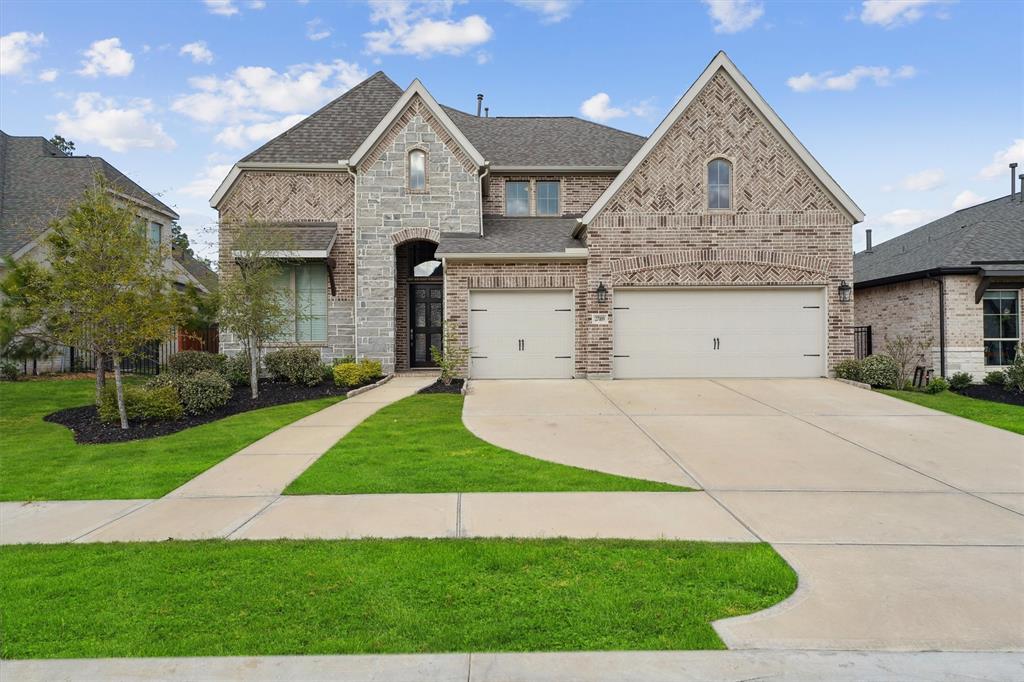 a front view of a house with a yard and garage