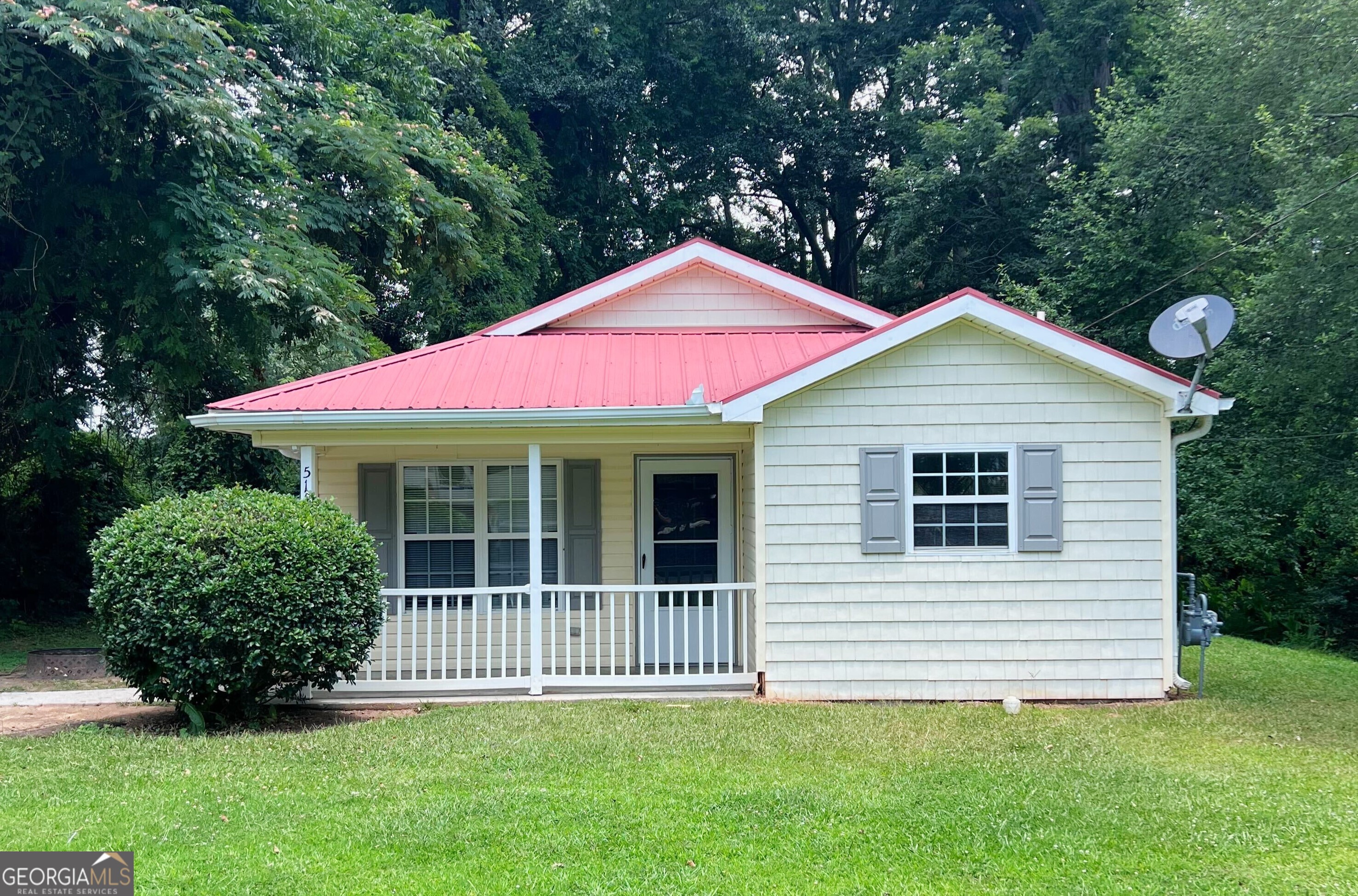 a view of a house with a yard and plants