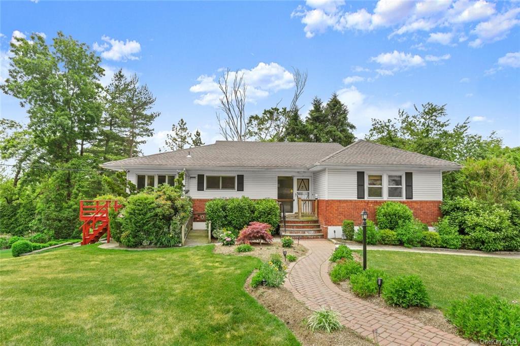 a front view of house with yard and green space