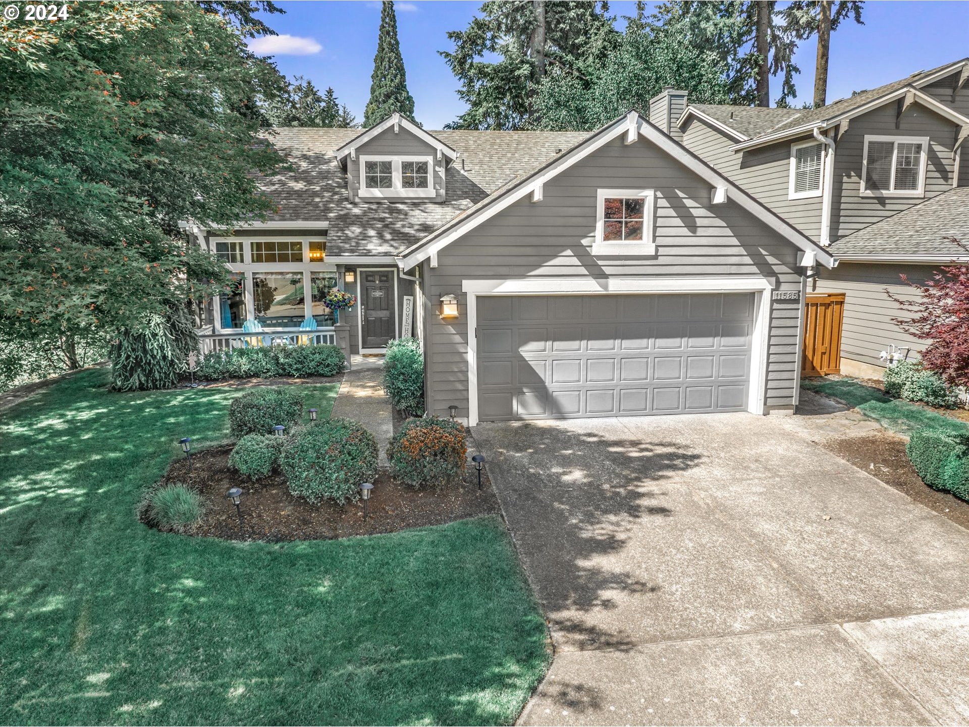 a front view of a house with a garden