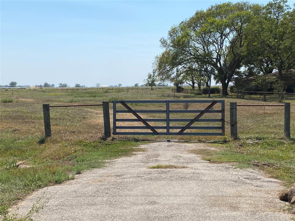 a view of a yard with wooden fence