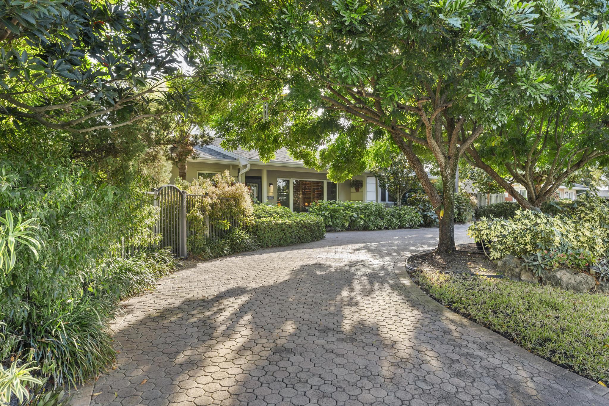 a front view of a house with a yard and trees