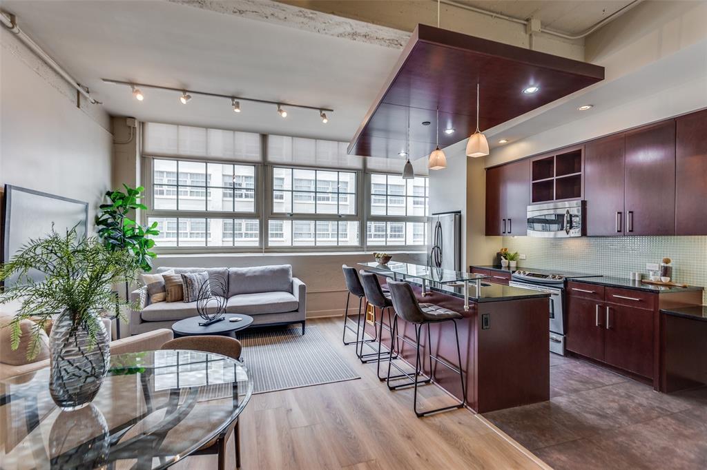 a living room with furniture a dining table and chairs