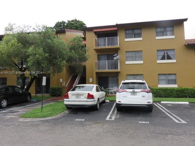 a view of a car parked in front of a brick house