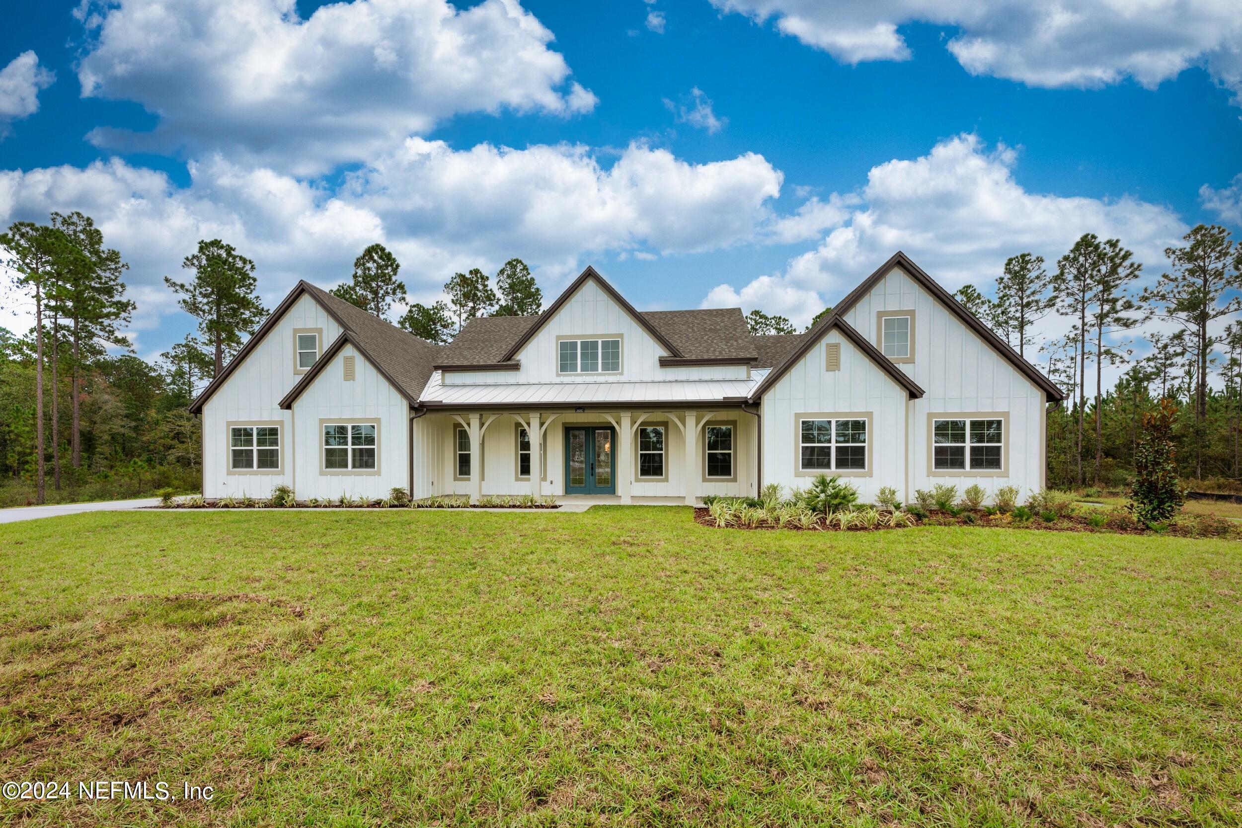 a front view of a house with a garden