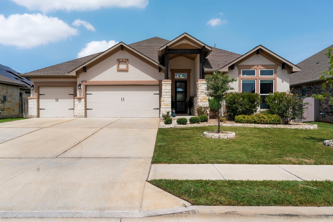 a front view of a house with a yard