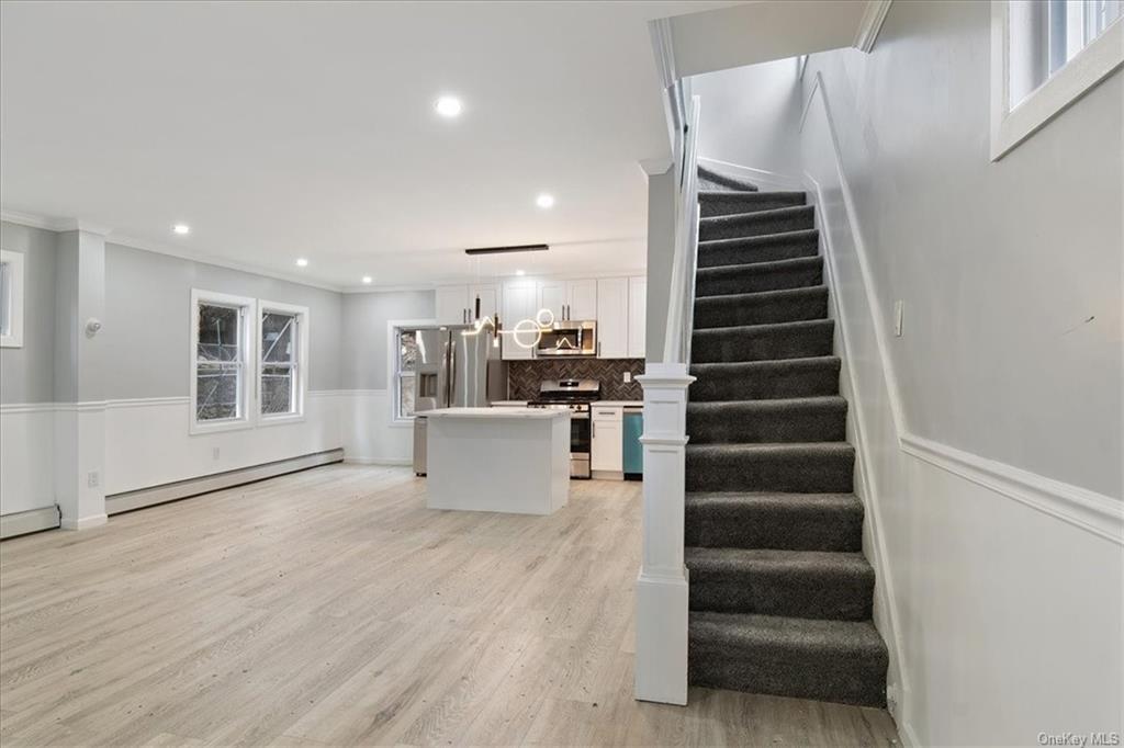 a view of a kitchen with furniture and staircase